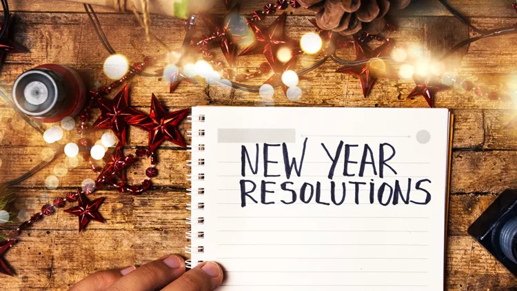 Person writing new year resolutions
