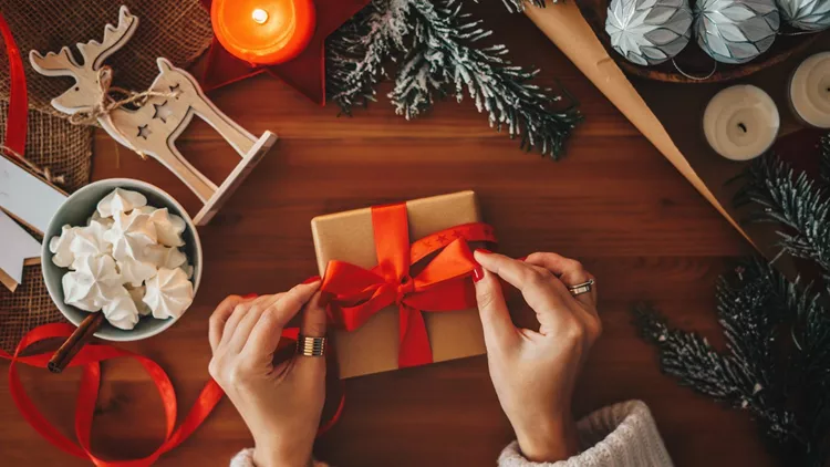 Woman wrapping Christmas gifts, overhead shot
