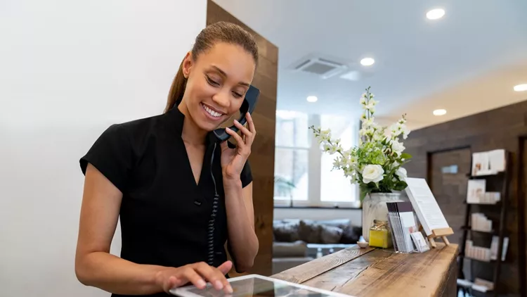 Woman working at a spa talking on the phone