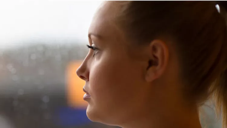 thoughtful-woman-looking-out-the-window-picture-id671473144