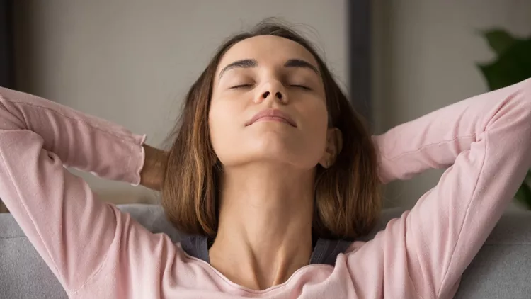 Close up front view woman closed eyes resting on couch