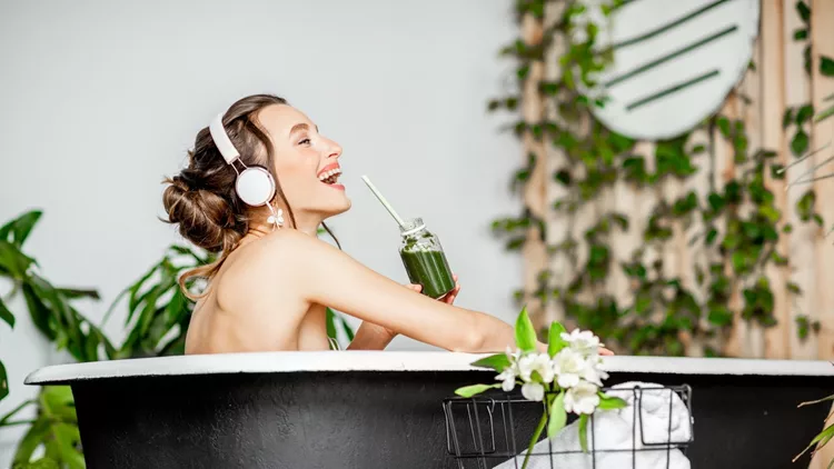 Young woman relaxing in the bathtub