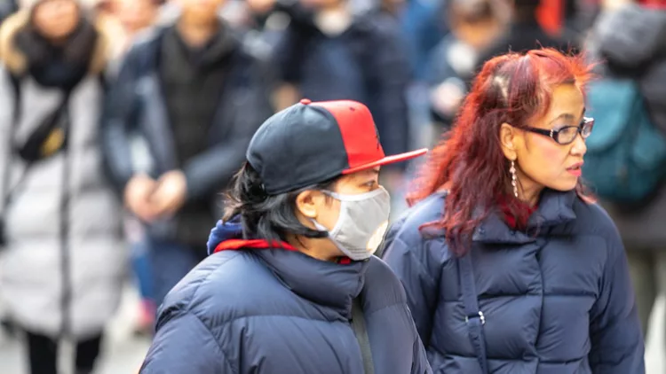 People wearing a face masks to protecting themself because of epidemic in China. Selective Focus. Concept of coronavirus quarantine.