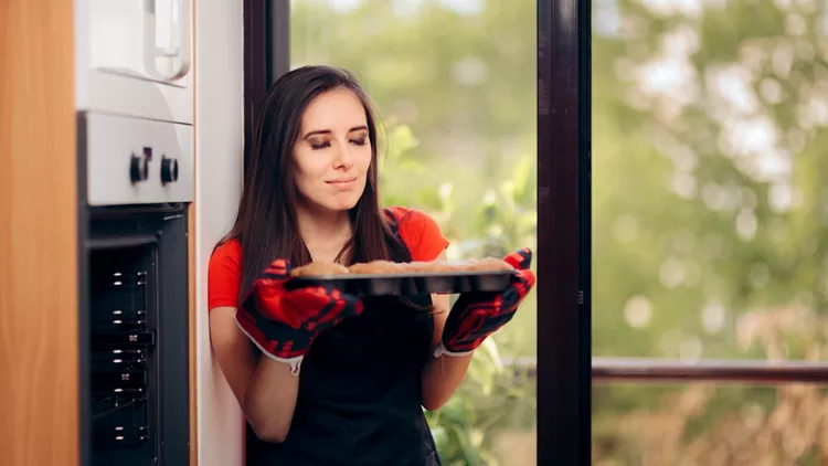 Woman Admiring her Delicious Cupcake fresh of the Oven