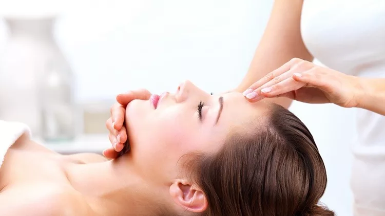 Close up of a young woman receiving facial massage