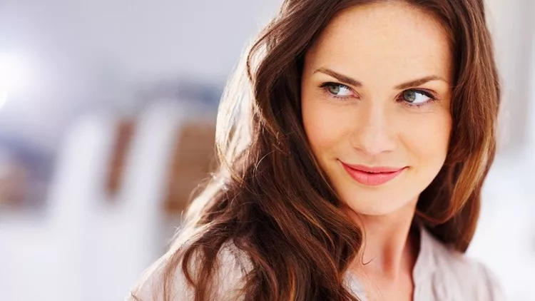 Happy middle aged woman looking away