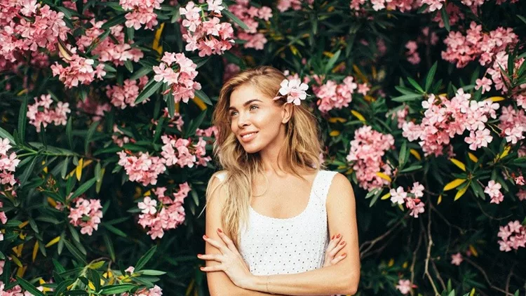 Beautiful girl on the background of spring bush