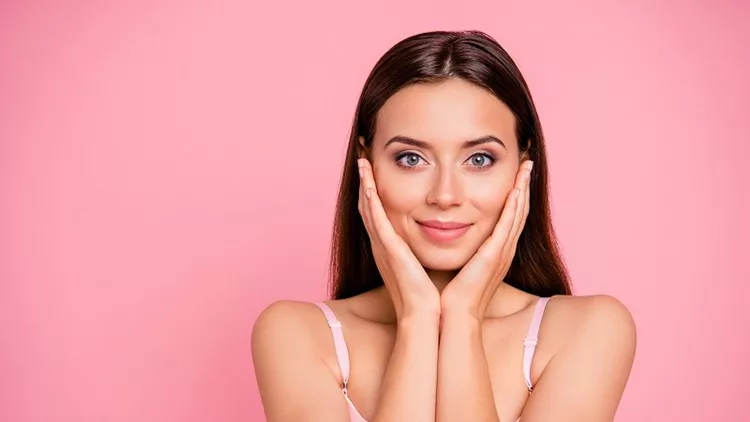 Close up portrait of beautiful cute gentle trying scrub effect touching skin with arms her she young girl wearing pale pink bra isolated on rose background