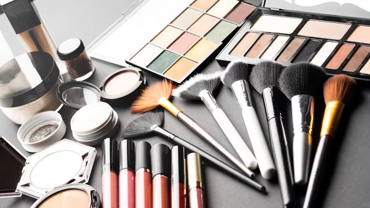 Multiple cosmetic products on black background.