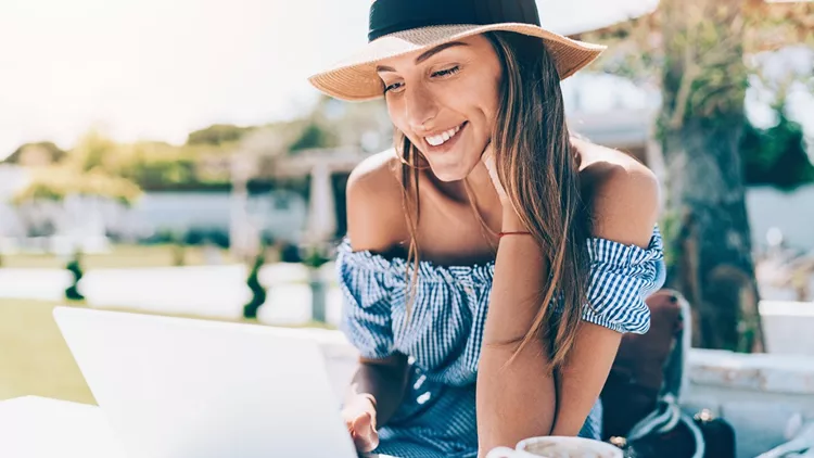Young woman with laptop in the garden