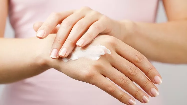 beautiful woman hands with cream