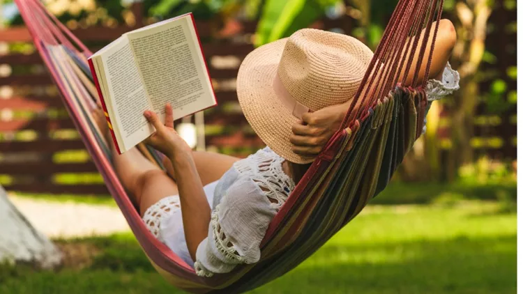 attractive-sexy-woman-reading-book-in-hammock-picture-id1145393520(1)