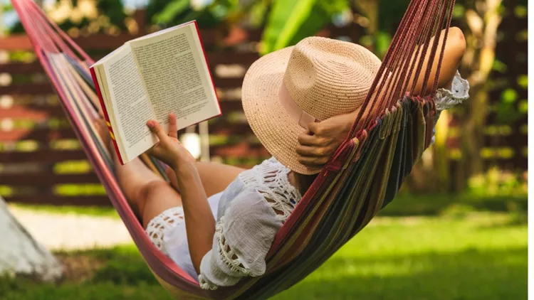 attractive-sexy-woman-reading-book-in-hammock-picture-id1145393520(1)