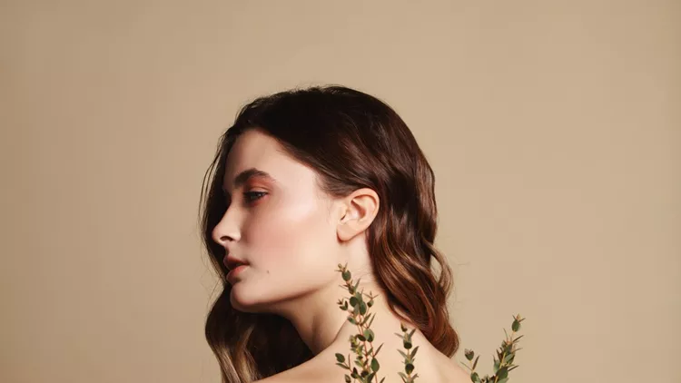 Young beautiful girl and plant