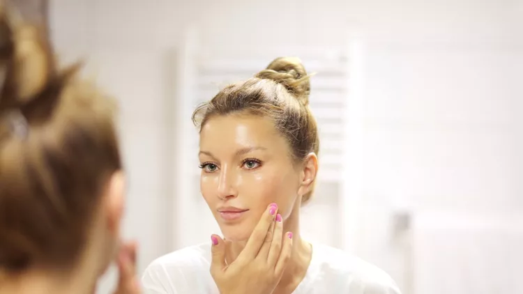 Magic anti-aging cream.Applying the cream