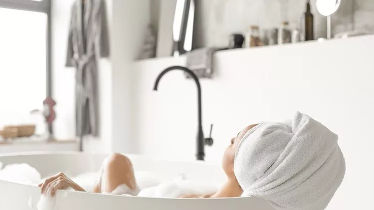 Young attractive woman relaxing in bathtub