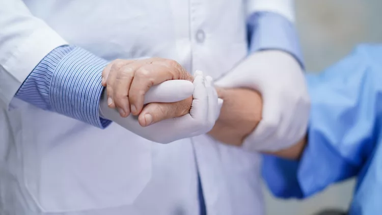 Doctor holding touching hands Asian senior or elderly old lady woman patient with love, care, helping, encourage and empathy at nursing hospital ward : healthy strong medical concept