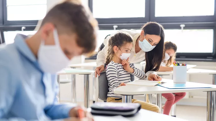 Group of children with face mask back at school after covid-19 quarantine and lockdown.