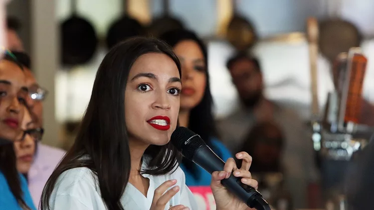 Rep. Alexandria Ocasio-Cortez Waits Tables At A New York City Restaurant