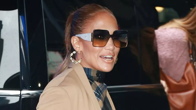 Jennifer Lopez Arrives At 'Good Morning America' Wearing A Tartan Dress And A Brown Trench Coat In New York City
