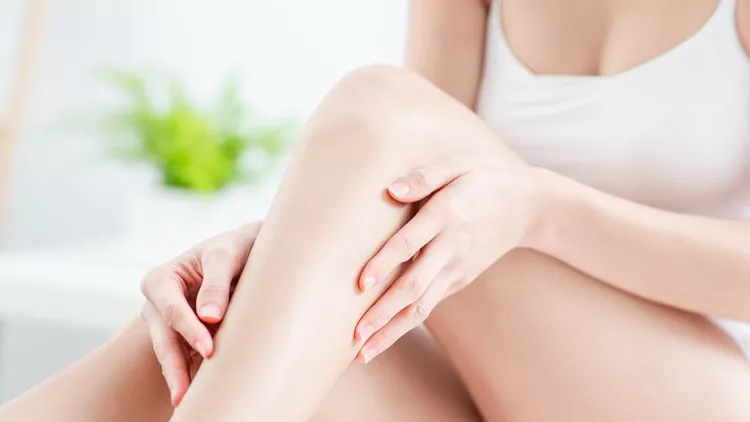 woman touching perfect shaved legs