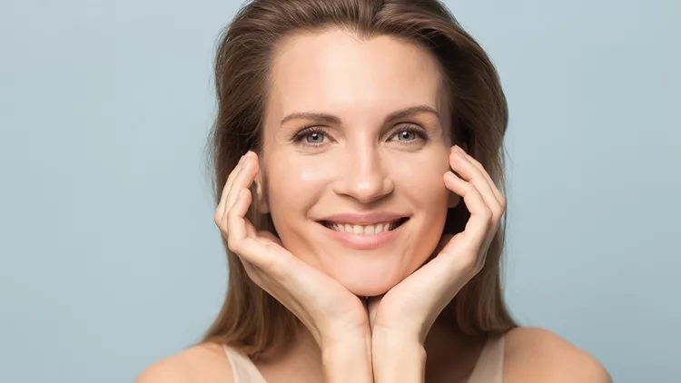 Portrait of smiling millennial woman with healthy skin