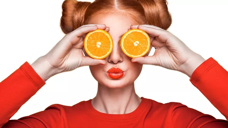 Young beautiful girl with orange.