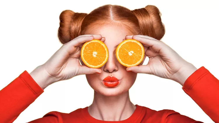 Young beautiful girl with orange.