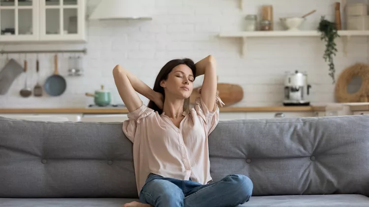 Woman enjoy free time resting on couch at home