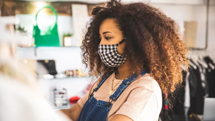 Woman shopping protecting herself wearing protective mask