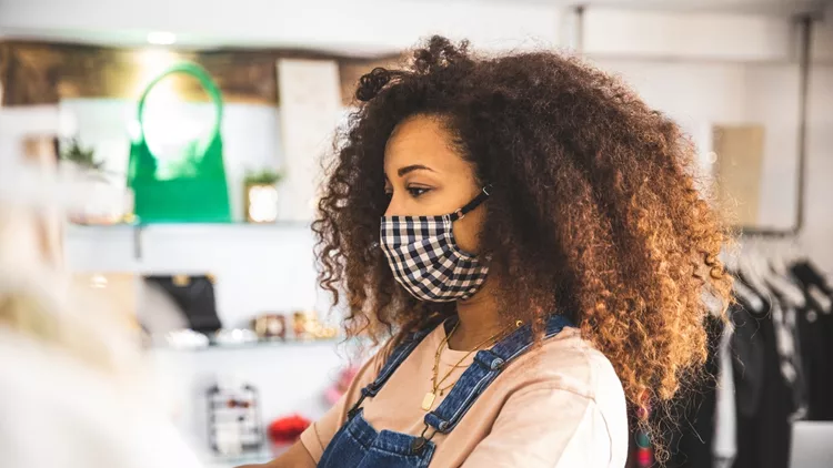 Woman shopping protecting herself wearing protective mask