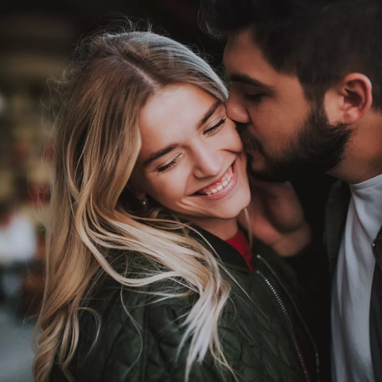 Beautiful young couple expressing their feelings on the street