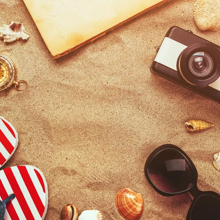 Beach ready, summer holiday vacation accessories on sandy beach