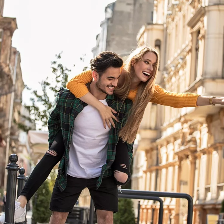 Smiling beautiful couple dating outdoors.