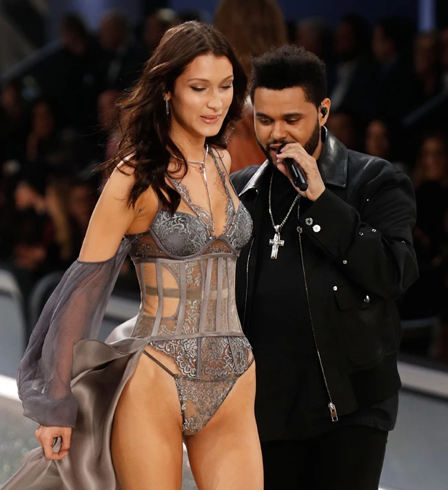 Bella Hadid gets brushed off by her ex-bf The Weeknd when she tries to touch him as she's walking by him at the 2016 Victoria's Secret Fashion Show in Paris, France.  Bella tried to touch him as she strutted by but he put his arm up and backed away as she tried to do so. Pictured: Bella Hadid,The Weeknd Ref: SPL1401994 011216 Picture by: Jackson Lee / Splash News Splash News and Pictures Los Angeles:310-821-2666 New York: 212-619-2666 London: 870-934-2666 photodesk@splashnews.com 